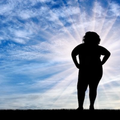 Woman with obesity looking at the horizon.