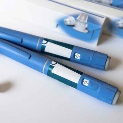 Ozempic pens on a white table.