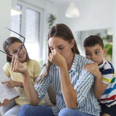 Stressed mother with her children.
