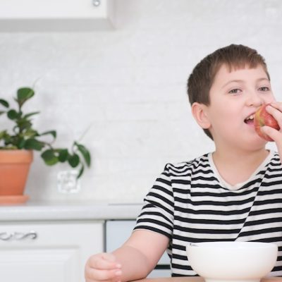 Boy eating at a Kitchen table.