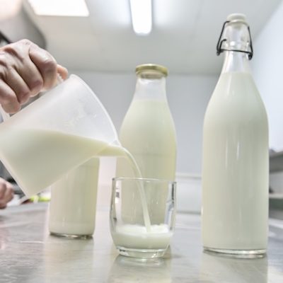Pouring milk from a jug into a glass.