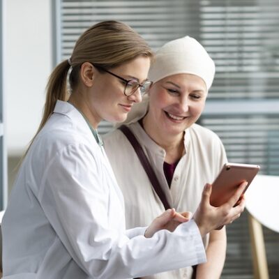 Woman with cancer speaking with her doctor.