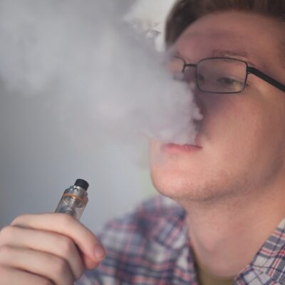 Young man vaping.
