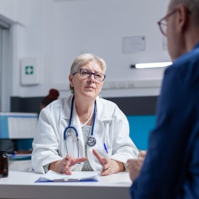 Doctor and patient meeting at consultation appointment to do healthcare checkup.