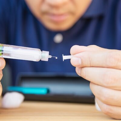 Man using a syringe.