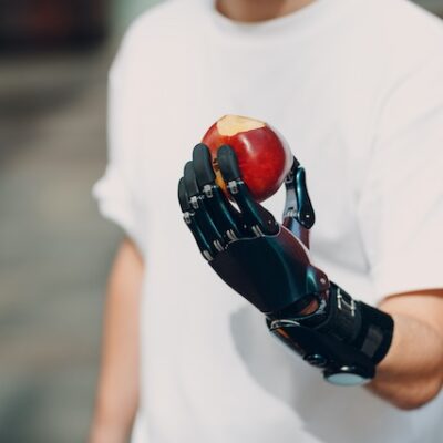 Young disabled man with artificial prosthetic hand in casual clothes.