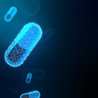 Glowing blue polygonal pills on dark background.