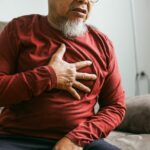 Senior Man Holding His Chest And Feeling Pain Suffering From a Heart Attack.