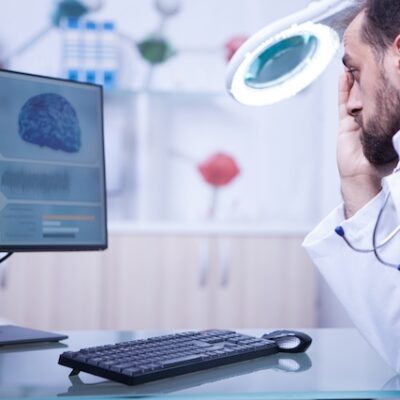 Doctor in a hospistal laboratory reading an x-ray.