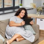 Woman with obesity using a tablet computer.